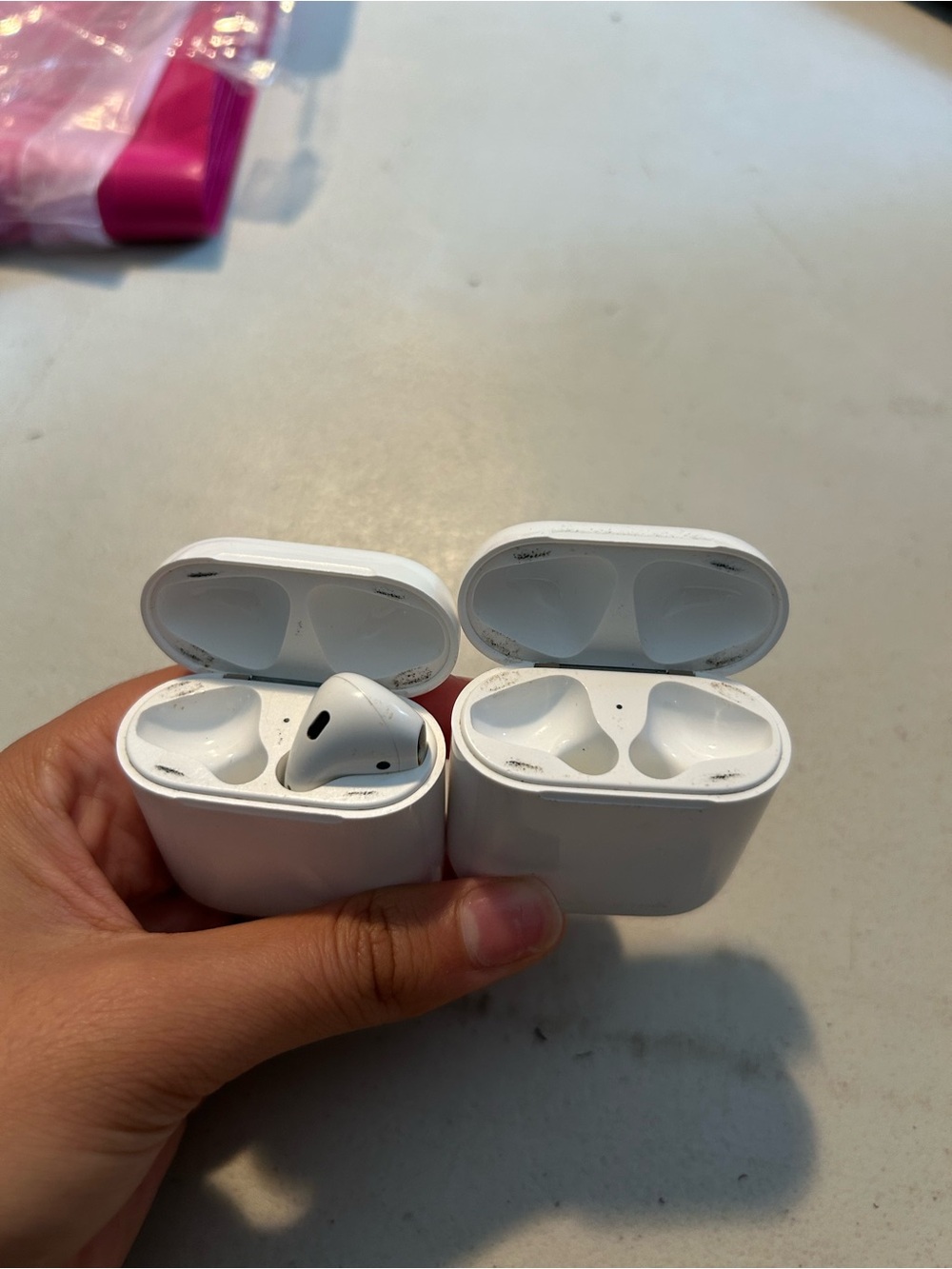 Two AirPod cases and AirPod parts